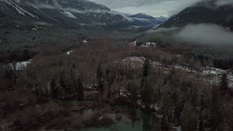 Cloudy-Aerial-tilting-shot-of-winter-valley-on-Vancouver-island,-Canada