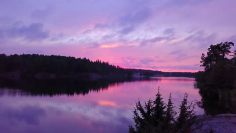 Moving-towards-a-lake,-at-purple-sky,-colorful-sunset-or-dusk,-at-Albysjon,-Tyreso,-Sweden