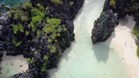 Aerial-of-Hidden-Beach-pedestal-down-tilting-up-on-limestone-cliffs-in-El-Nido,-Palawan,-the-Philippines