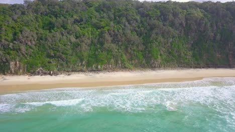 Spectacular-aerial-flight-away-from-cliffs-and-trees-over-wild-ocean,-Australia