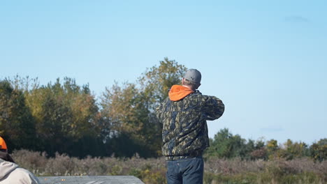 A-man-at-a-shooting-range,-firing-a-round-with-a-rifle