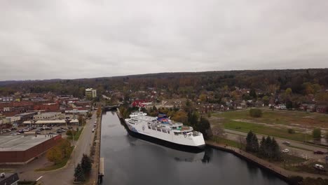 Rising-drone-footage-away-from-the-Chi-Cheemaun-while-it-is-docked-in-Owen-Sound,-Ontario