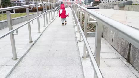 Laufendes-Kind-Mit-Roter-Jacke-Und-Weißem-Schal
