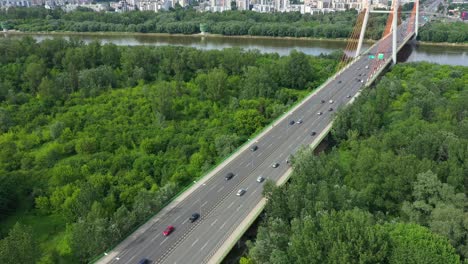 Aerial-shooting-from-flying-drone-car-traffic-on-modern-highway-bridge-over-river