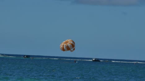 A-man-touching-the-water-and-going-up-again-while-practices-parasailing