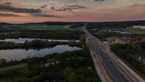 Aerial-Drone-Hyperlapse-of-German-Motorway-near-a-Lake-at-Sunset