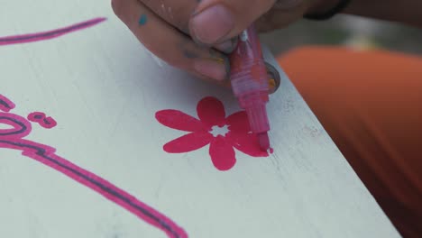 Painting-vibrant-flower-on-sign