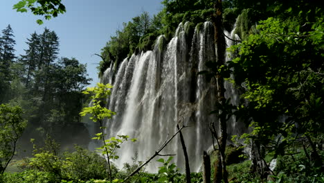 Big-waterfall-hidden-behind-the-leaves-of-the-trees