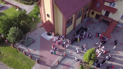 Aerial-shot-of-a-wedding-ceremony-in-a-small-church-on-a-coutryside