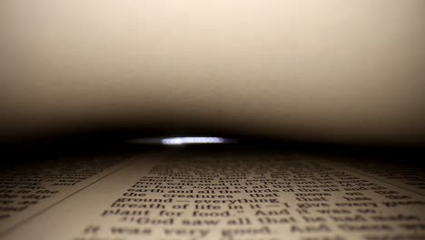 GENESIS-Slowly-pushing-lens-into-a-book,-center-view-of-the-page