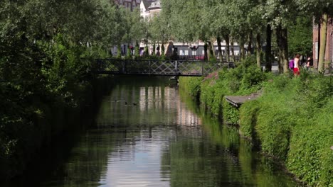 Aboulevarden-in-central-Aarhus,-Denmark-a-nice-summer-morning-with-tourists-looking-at-the-river-and-taking-photos-of-the-sights