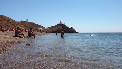 People-Relaxing-At-Cala-Del-Corralete,-Cabo-De-Gata