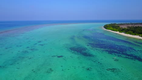Hermosa-Playa-En-Indonesia-Con-Arena-Blanca-Al-Lado-De-Los-Exuberantes-árboles-Verdes-Y-Un-Agua-Azul-Pura-En-El-Mar---Tiro-Aéreo