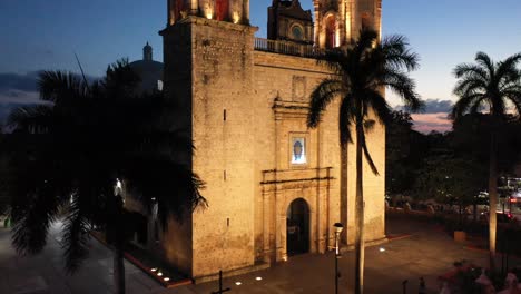 Nighttime-aerial-ascent-from-corner-of-church-showing-closeup-of-the-Cathedral-de-San-Gervasio-in-Valladolid,-Yucatan,-Mexico