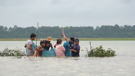 Medium-Shot-of-People-Fishing-on-the-Lake-Collecting-a-Fishing-Net