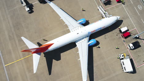 Tracking-shot-of-a-Sunwing-airplane-taxiing-to-its-arrival-terminal-gate