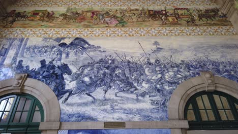 Blue-and-white-azulejo-tile-art-depicting-Battle-of-Valdevez-in-Sao-Bento-Train-Station-in-Porto,-Portugal
