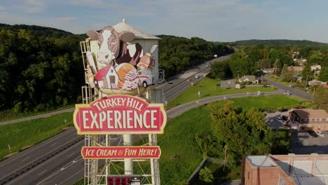 Aerial-trucking-shot-of-Route-30-traffic-beside-Turkey-Hill-Experience-tourist-attraction-billboard