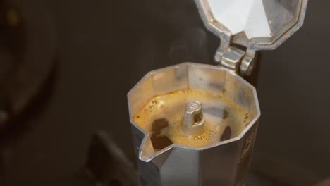 Coffee-brewing-in-half-full-moka-coffee-pot,-close-up