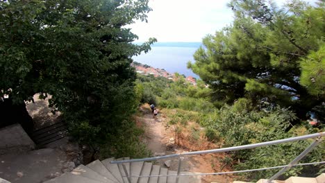Footpath-downhill-from-Fortica-fortress-on-the-hill-over-Omis-and-people-walking-on-it