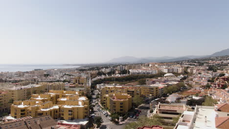 Wide-rising-aerial-orbit-shot-of-sunny-Marbella-on-early-spring-day