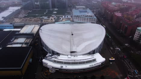 Scandinavium-from-above-during-a-foggy-day-in-Gothenburg,-arc-shot