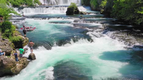 Spectators-watching-people-Whitewater-rafting-at-River-Una,-Bosnia