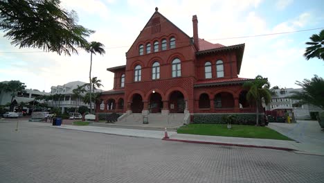 Wide-View-of-Key-West-Art-and-History-Museum-Tracking-Left-With-Street-Post-in-Foreground