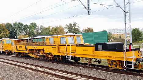 Panorama-of-a-yellow-service-wagons-on-a-railway-platform