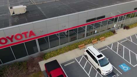 Aerial-of-Toyota-car-dealership,-Japanese-imported-cars-to-US-for-sale-and-service