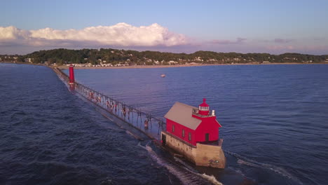 Aerial-view-of-wavy-water-and-people-walking-by-Grand-Haven-Lighthouse