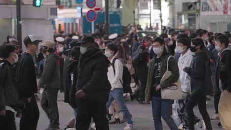 People-Wearing-Masks-At-Shibuya-Crossing-In-Tokyo,-Japan-On-Halloween-Night---medium-shot,-slow-motion