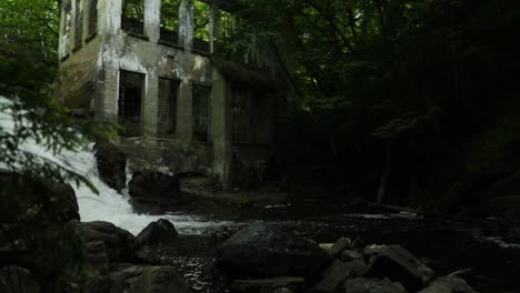 Beautiful-ruins-of-a-old-mill-in-the-middle-of-the-forest-with-a-waterfall-running-through-the-ruins-in-Gatineau,-Quebec