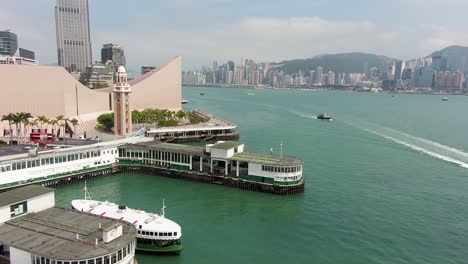 Tsim-Sha-Tsui-pier-with-ferry-docked-in-downtown-Hong-Kong,-Aerial-view