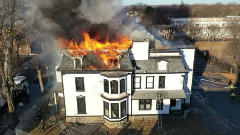 A-Historic-Victorian-House-Fire-on-a-Sunny-Day,-Slow-Approach-Aerial-Shot