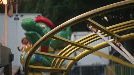 Children-riding-small-roller-coaster-at-carnival,-Slow-Motion