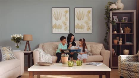 Wide-angle-dolly-out-of-single-mum-with-her-children-reading-nursery-book