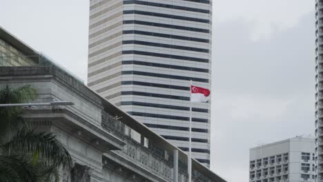 Flag-Of-Singapore-Waving-In-The-Wind-At-The-National-Gallery-In-Singapore---low-angle-shot
