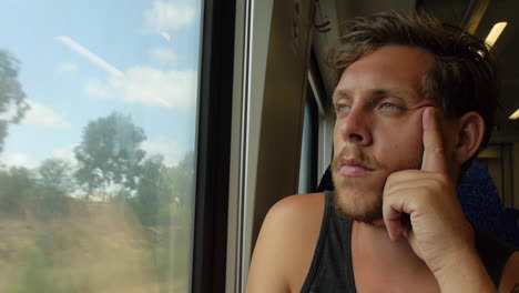 Man-on-Train-Stares-Out-the-Window,-Longing-and-Deep-in-Thought