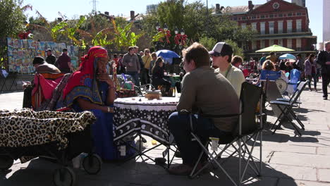 Tarotkartenleser-Mit-Zwei-Kunden-Auf-Einem-Belebten-New-Orleans-Square