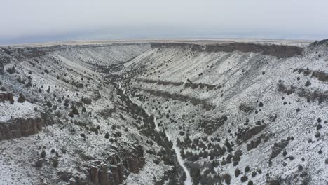 Slow-tracking-drone-shot-of-snowy-canyon