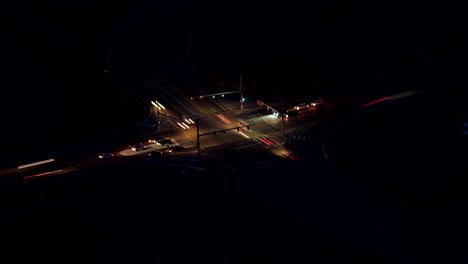 Aerial-time-lapse-of-night-time-traffic-flow-at-a-highway-intersection