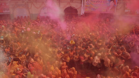 People-are-celebrating-below-surrounded-by-colored-dirt-in-the-air