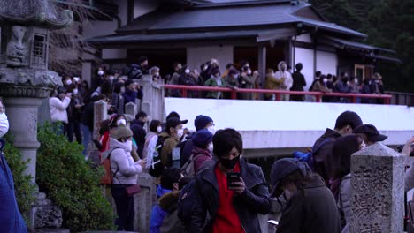 Dense-crowd-of-tourists-standing-on-top-of-observatory-with-facemasks-during-Corona-Crisis