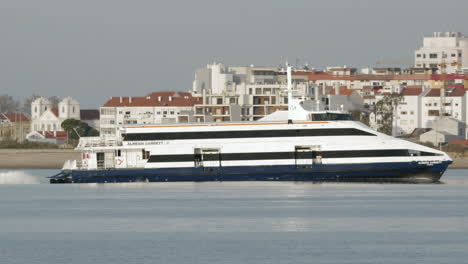 Tourismus-Schnellbootfahrt-Auf-Dem-Tejo-An-Sonnigen-Tagen-Mit-Wohngebiet-Von-Lissabon-Im-Hintergrund