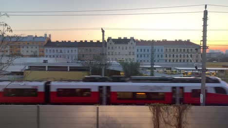 Various-scenes-of-commuter-trains-passing-in-front-of-buildings-in-the-city-of-Vienna,-Austria