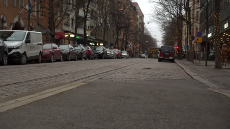 Low-angle-view-of-parked-cars-on-paved-street-in-Helsinki