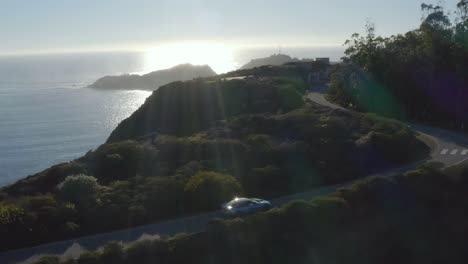 Blue-BMW-i8-on-picturesque-road-in-Marin-Headlands,-California-USA,-aerial-view