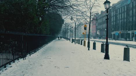 Fresh-snowfall-in-Dublin-city-centre-couple-walking-down-street