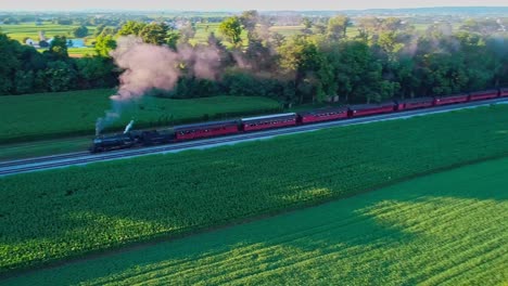 Steam-Train-at-Picnic-Area,-Pulling-out-of-Picnic-Area,-in-Amish-Countryside-as-seen-by-Drone